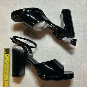 Black patent heels with ankle strap. New in box. Size 10.